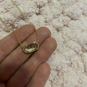 Kendra Scott gold necklace with light pink pendent